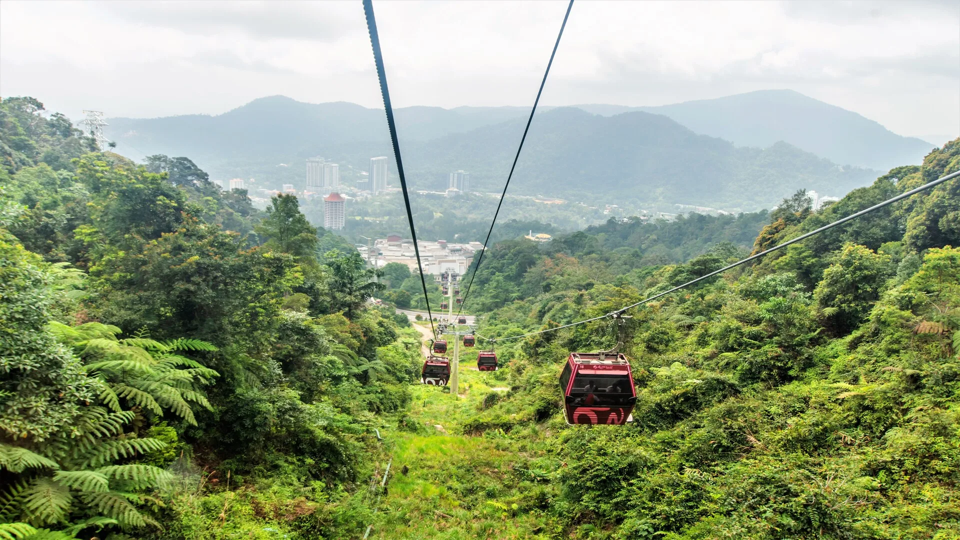 Genting Skyway gondolas above the rainforest, with the resort towers beyond